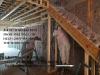 Cellulose insulation is sprayed into wall cavities.