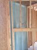 Spray foam insulates and air seals the exterior wall behind the fireplace.