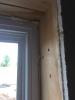 Non expanding spray foam is used to fill  the rough openings around windows.