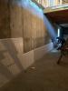 Right – Construction adhesive is applied to the rigid foam panels that will be installed on the interior basement walls.