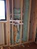 Right – Spray foam is used to carefully seal behind plumbing that was installed in an exterior wall.