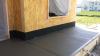 Right – The base of the wall is water proofed and the seam between the base of the wall and the sidewalk is air sealed.