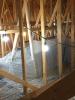 Right – Plastic tenting increases the height of the insulation above ducts that are located in the attic.