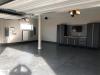 Right – The PV system inverters and battery take up minimal space in the garage.