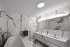 The solar tube installed in the ceiling of this bathroom brings natural light into an interior room that doesn’t have window access.