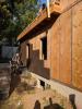  Taped plywood provides an air barrier beneath the cork insulation installed on the exterior of this home.  