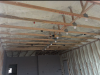 Right – The underside of this low-sloped roof is insulated with open-cell spray foam in this dry climate to achieve the code-required R-value; the builder used the same foam to insulate exterior walls. 
