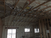 Right – Spray foam insulation is sprayed on the underside of the roof deck to provide a conditioned space in this low attic for the HVAC ducts.