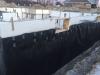 Right - A dimpled-plastic geotextile mat covers the below-grade insulated concrete form (ICF) foundation to help keep water out of the foundation and to reduce hydrostatic pressure on the foundation during freeze-thaw cycles in winter.
