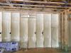 Right – the 2x6 walls are insulated with a flash-and-batt approach that includes spraying the wall cavities with one inch of open-cell foam to seal the sheathing to the framing then filling the wall cavities with R-19 fiberglass batts that are compressed slightly to fill the cavities.