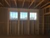 Right – The window header is filled with spray foam and sealant is used to air seal wood-to-wood seams; however, it would be preferable to design the wall to avoid so many stacked studs around the windows because they prevent the installation of wall insulation and lead to cold spots.