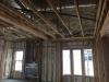 Right – Spray foam air seals and insulates the walls including the walls behind the fireplace and covers the underside of the roof deck of this mixed-dry climate home to provide an insulated attic space for HVAC ducts.