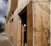 Right – A 1-inch layer of XPS rigid foam covers the 2x6 wall studs and is topped by ½-inch-thick plywood sheathing, which is covered with draining house wrap and serves as a nailing surface for siding and trim.