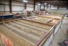 Right – Walls, windows, and wiring are installed in the factory for these modular homes, which are installed at the site on basement foundations made of insulated concrete wall panels.