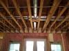 Right – Fiberglass batt insulation fills the walls while the floor joists above are insulated with spray foam insulation to both insulate and air seal this transition space.
