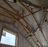 Right – R-23 of blown fiberglass fills the walls and unvented vaulted attic cavities of this marine-climate home while an additional R-20 (4-inches) of graphite-enhanced expanded polystyrene is installed above the roof sheathing.