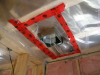 The polyethylene ceiling vapor barrier is sealed to form an air barrier around the exhaust fan in this very cold climate location (≥ CZ 6).