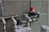 An earthquake-actuated automatic gas shutoff valve is attached to the natural gas pipeline between the meter and the house, downstream of the meter, to stop the flow of gas into the house if an earthquake occurs. 