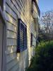 These aluminum Bahama shutters shade west-facing windows from afternoon sun and are approved for hurricane protection 