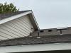 Two exhaust fan vents (with angled hoods) are visible on the roof and another exhaust vent (with angled hood) is visible on the wall of this home.