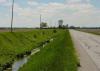 Berms are compacted earth or gravel ridges that slow the flow of water from rain, riverine flooding, or storm surges in coastal areas.