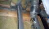Sheet metal and mastic provide air sealing around a flue pipe. 