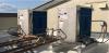 Wrong: The exhaust air from one heat pump water heater is blowing into the intake of the heat pump water heater next to it  