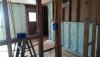 In this gut rehab, drywall was removed then a sprayer-applied sealant was used to seal all large cracks and seams and then the 2x4 walls were filled with spray foam.
