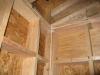 A large bead of caulk is installed on the interior surface of the wall top and bottom plates to provide an air sealing gasket between the framing and the dry wall.
