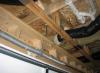 In cold climates, plumbing pipes should not be located in the building cavities over the garage