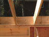 Right - Blocking has been installed between the ceiling joists and air sealed in place with canned spray foam to stop air flow beneath the attic knee wall.