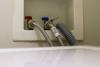 When installing a new clothes washer, connect the hot, cold, and drain hoses; the drain hose should extend less than 6 inches into the drain to allow an air gap so that water doesn’t get siphoned back into the washing machine.