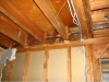 Wrong - When ceiling joists over a garage run perpendicular to the adjoining wall, the joist bays must be blocked and sealed to prevent garage fumes from entering the living space