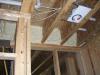 Right – Closed-cell spray foam insulates and air-seals the rim joist above a shared wall between the garage and living space.