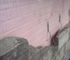 Drainage behind stone cladding is provided by “grooved” rigid insulation coupled with a filter fabric.