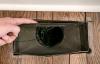 This air register has noticeable gaps between it and the floor; use canned spray foam to fill in the gaps.