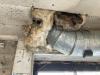 The fiberglass insulation stuffed into the large hole around this HVAC duct will not prevent air leakage from the unconditioned basement to the conditioned space above; the large gap should be sealed with a rigid air barrier and caulked or spray foamed. 