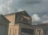 End wall failure under hurricane force winds due to inadequate bracing of the gable end wall.