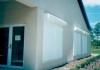 The light-colored exterior roll-down shades on this building, and the shaded entryway provide very effective control of solar heat gain