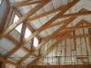 The walls and ceilings of this post-and-beam home are filled with netted blown fiberglass.