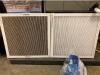 A comparison of a dirty furnace filter on left and clean filter on right. Dirty filters block airflow and make the furnace or air handler work harder.