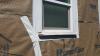 Wrong - The flashing tape is poorly adhered to the window.