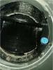 This constant airflow regulator (CAR) has been fouled by aerosolized sealant because it was not covered while the ducts were being sealed with the aerosolized acrylic sealant. 