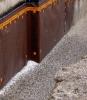 This building foundation has a drainage layer located on the exterior of the waterproofing membrane. 