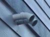 Wrong - The furnace intake and exhaust are too close to each other and should be facing different directions.