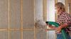 A trained installer completely fills the wall cavities with sprayed cellulose insulation. 