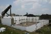 Concrete is being poured into the wall forms made by the rigid foam insulated concrete form blocks. 