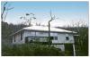 This hip-roofed home survived high winds with little to no damage. 