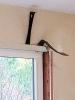 Use pry bars to remove the trim around an existing window to access the rough opening