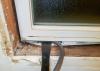 Use a pry bar or dull putty knife to push backer rod into the rough opening around an existing window